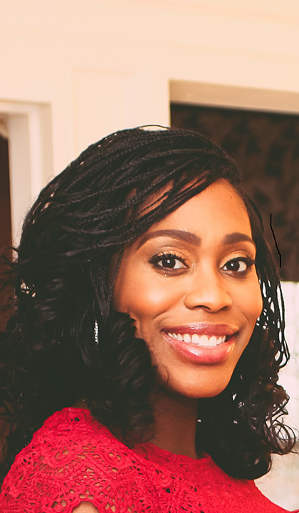 Image of Dr. Katrina Moore, a Black woman with her hair styled in curled braids, with a large smile and wearing a bright red shirt.