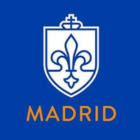 Image of SLU Madrid's white logo, a shield with the fleur de lis outlined, against a royal blue background. 
